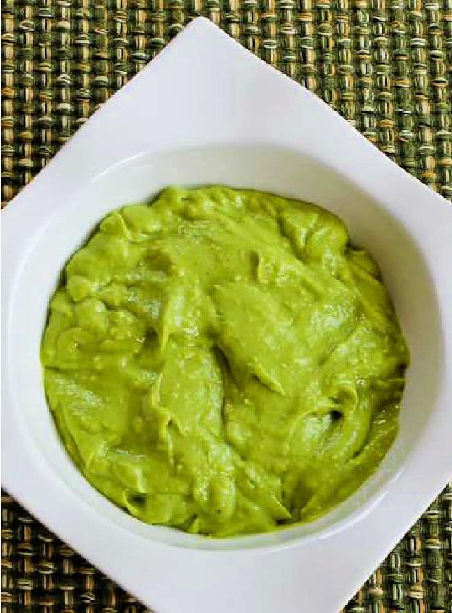 Easy Avocado Sauce shown in white bowl.